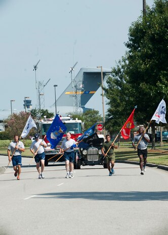 Members from each military branch  run with their respective service flags to the base parade grounds for the start of the Prisoner of War/Missing in Action Retreat ceremony Sept. 21, 2012, at Joint Base Charleston – Air Base, S.C. Teams from various joint base units held a running vigil at the base track, running the POW/MIA flag around the track for 24 hours. (U.S. Air Force photo / Staff Sgt. Katie Gieratz)