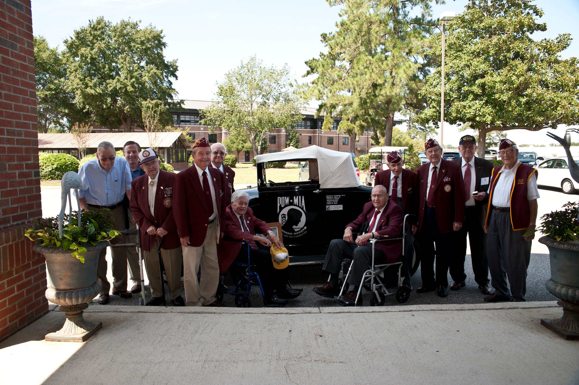 Ex-Prisoner of War members stop for a group photo in front of the Charleston club Sept. 21, 2012, at Joint Base Charleston – Air Base, S.C. Several ex-POWs, as well as family members of those who are MIA, from throughout the state of South Carolina attended the event as honored guests. (U.S. Air Force photo / Staff Sgt. Katie Gieratz) 