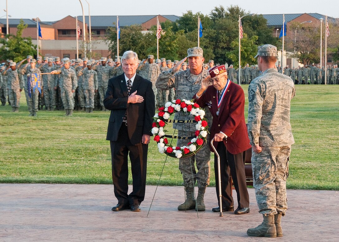 Wichita County Judge Woodrow "Woody" Gossom Jr., Brig. Gen. Michael Fantini, 82nd Training Wing commander, veteran Charles Hartney and Master Sgt. John Van Pelt, 366th Training Squadron, salute during POW/MIA wreath ceremony during the POW/MIA Recognition Day parade at Sheppard Air Force Base, Texas, parade field Sept. 21, 2012. Members of the base also particpated in a flag vigil during the day to honor the POW/MIA's. (U.S. Air Force photo/Frank H. Carter) 