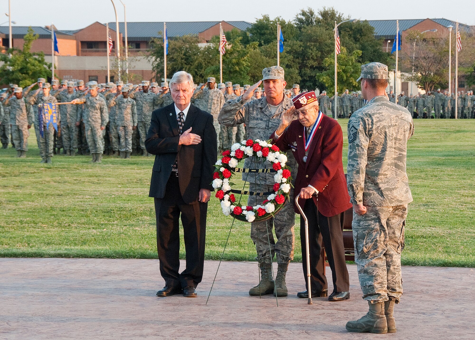 Wichita County Judge Woodrow "Woody" Gossom Jr., Brig. Gen. Michael Fantini, 82nd Training Wing commander, veteran Charles Hartney and Master Sgt. John Van Pelt, 366th Training Squadron, salute during POW/MIA wreath ceremony during the POW/MIA Recognition Day parade at Sheppard Air Force Base, Texas, parade field Sept. 21, 2012. Members of the base also particpated in a flag vigil during the day to honor the POW/MIA's. (U.S. Air Force photo/Frank H. Carter) 