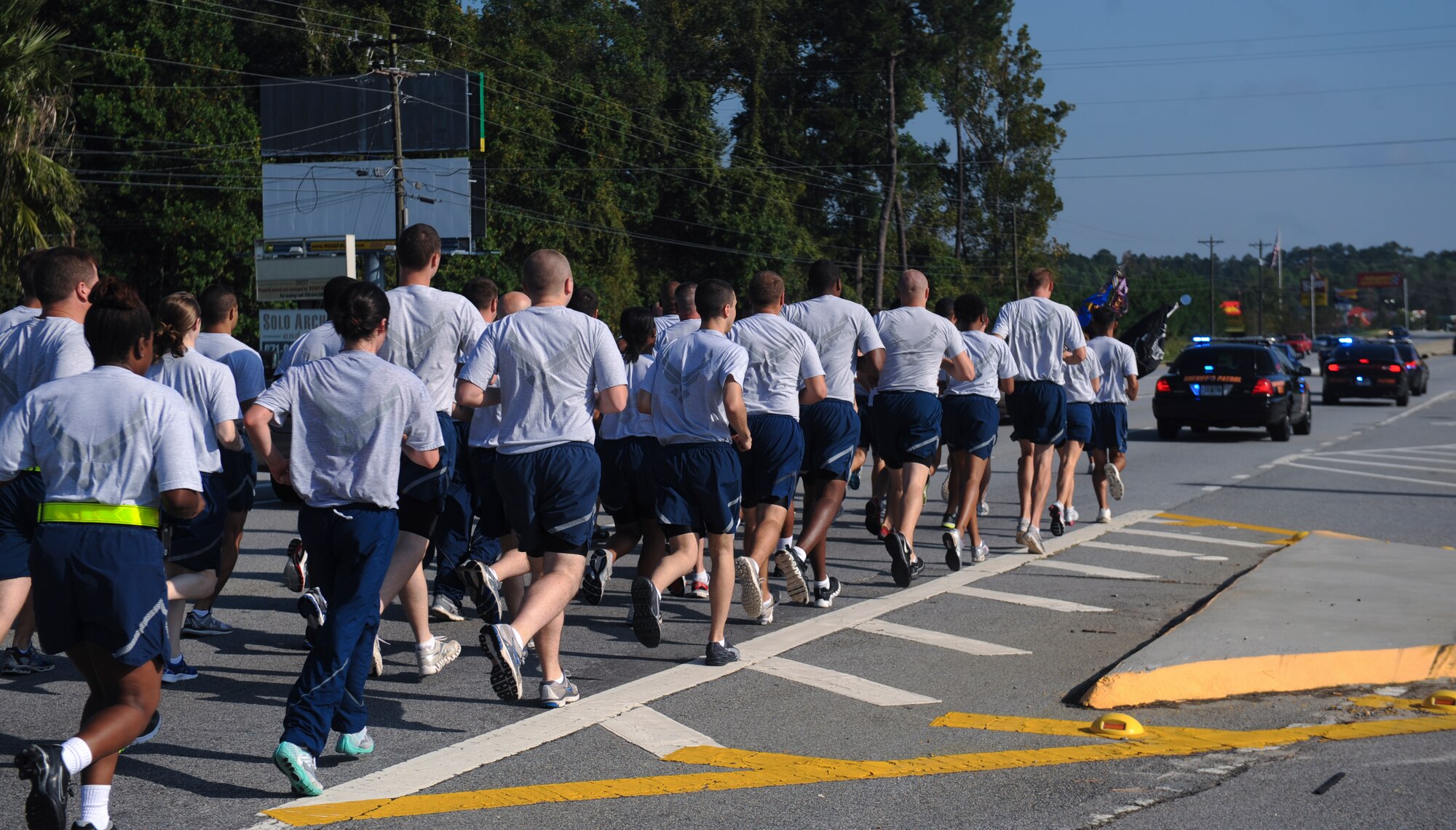 Members of the 38th Rescue Squadron make their way through the Davidson Road gate at Moody Air Force Base, Ga., Sept. 21, 2012. Team Moody ran a combined total of 23 miles to pay tribute to Prisoner of War/Missing in Action Recognition day. (U.S. Air Force photo by Airman 1st Class Olivia Dominique/Released)