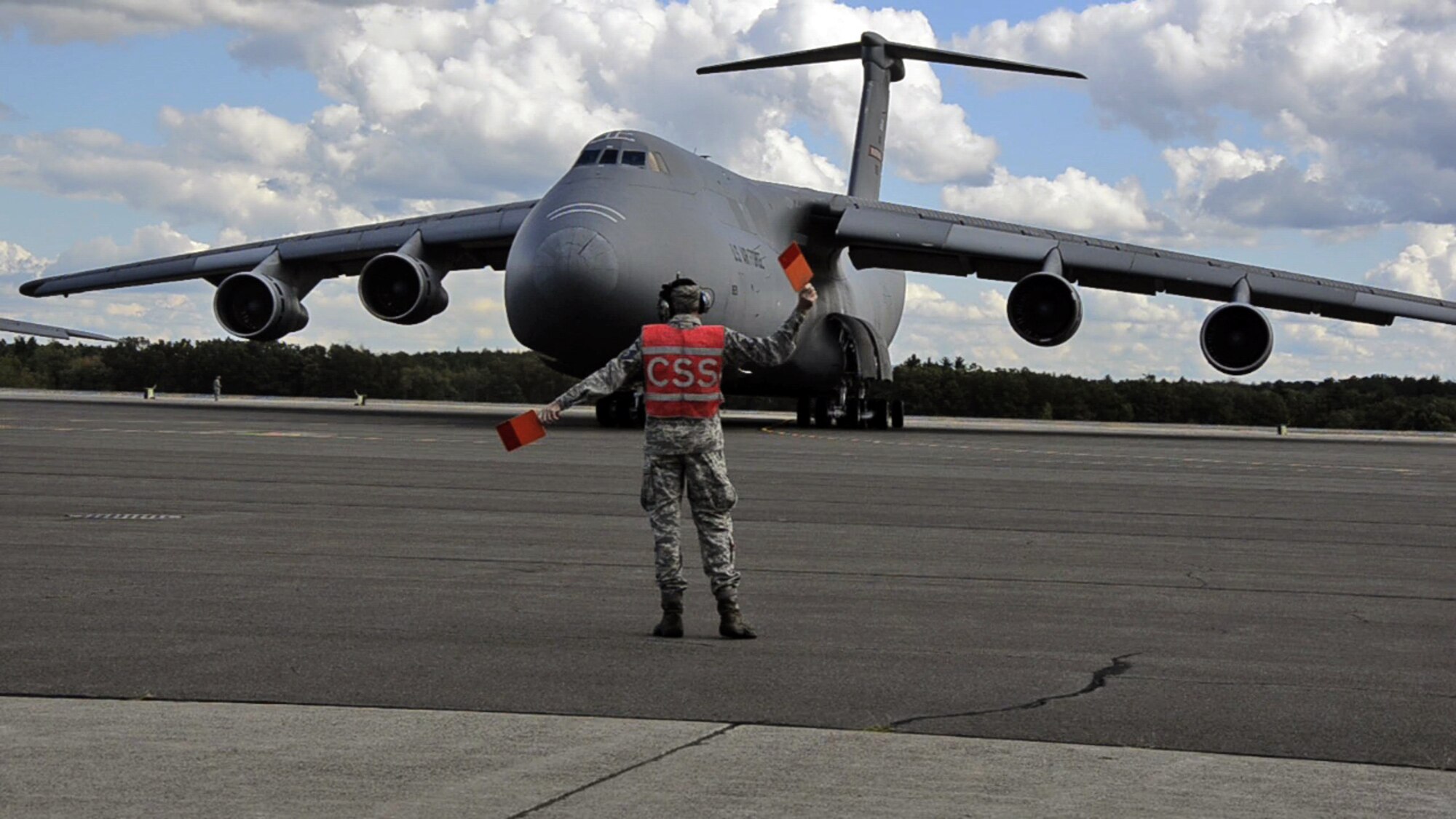MSgt. Art Needham was given the honor of marshalling "Miss Piggy" from its last parking spot here, for its flight to the "Bone Yard" at Davis-Monthan Air Force Base, Ariz. This C-5, tail number 0211, is an "A" model that has been stored here for over a year on the North Ramp with four others. Although this classic 1968 aircraft had a Martinsburg tail flash for its final flight, it was part of the Westover fleet years ago, and MSgt. Needham had served as its crew chief for 19 years. He nicknamed 0211 "Miss Piggy", which stuck, and as it lumbered into the sky for the last time, he said under his breath, "She served her country well." (Air Force photo by W.C.Pope)