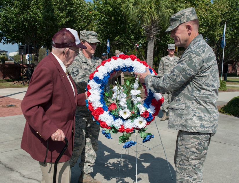Col. Richard McComb, Joint Base Charleston commander, and 89-year old Paul Hollen Army Air Corps veteran and World War II prisoner of war, pay their respects during the Prisoner of War/Missing in Action Retreat ceremony Sept. 21, 2012, at Joint Base Charleston – Air Base, S.C. (U.S. Air Force photo/Airman 1st Class Ashlee Galloway)