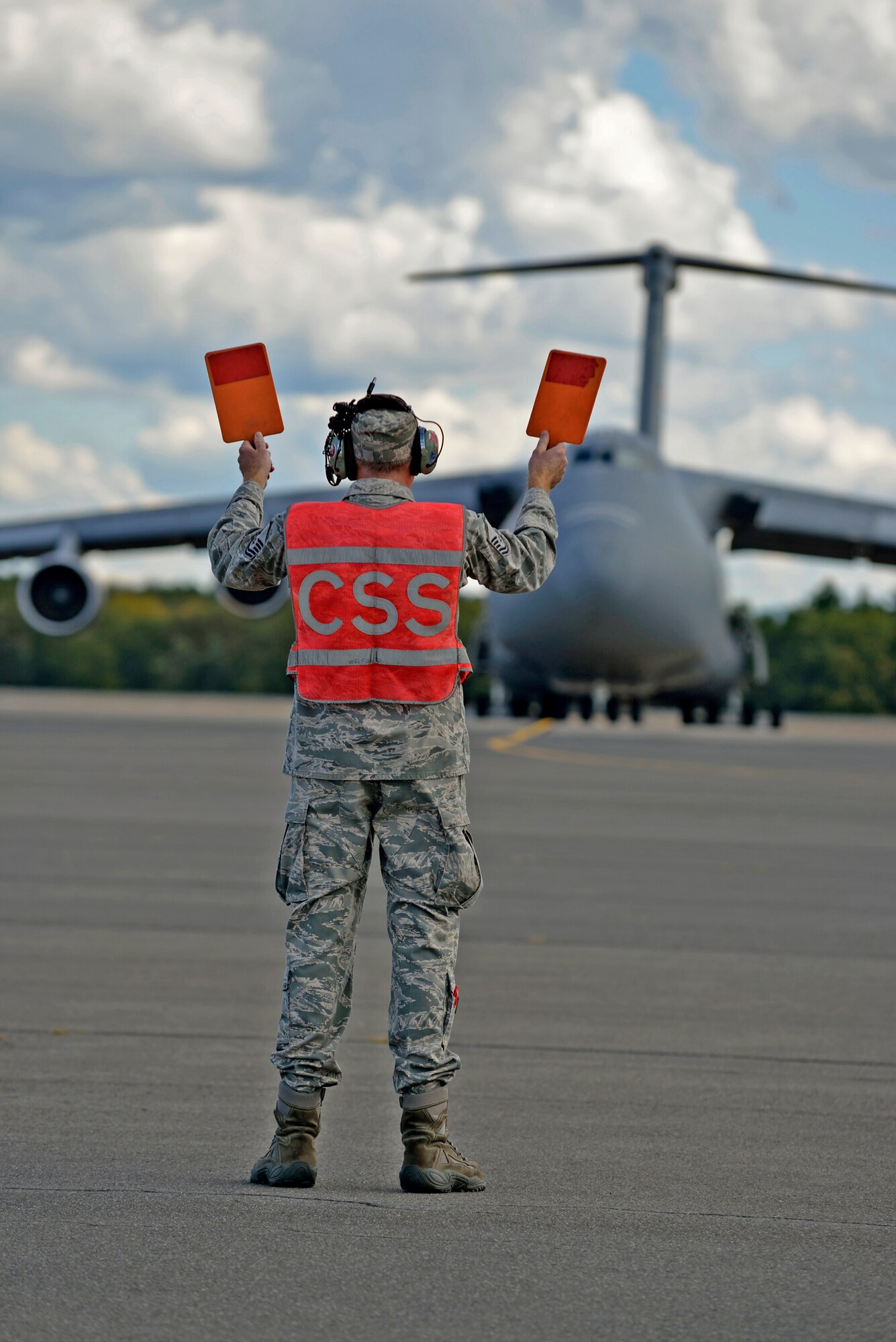 WESTOVER AIR RESERVE BASE, Mass. -- MSgt. Art Needham was given the
honor of marshalling "Miss Piggy" from its last parking spot here, for its flight to the "Bone Yard" at Davis-Monthan Air Force Base, Ariz. This C-5, tail number 0211, is an "A" model that has been stored here for over a year on the North Ramp with four others. Although this classic 1968 aircraft had a Martinsburg tail flash for its final flight, it was part of the Westover fleet years ago, and MSgt. Needham had served as its crew chief for 19 years. He nicknamed 0211 "Miss Piggy", which stuck, and as it lumbered into the sky for the last time, he said under his breath, "She served her country well." (Air Force photo by W.C.Pope)