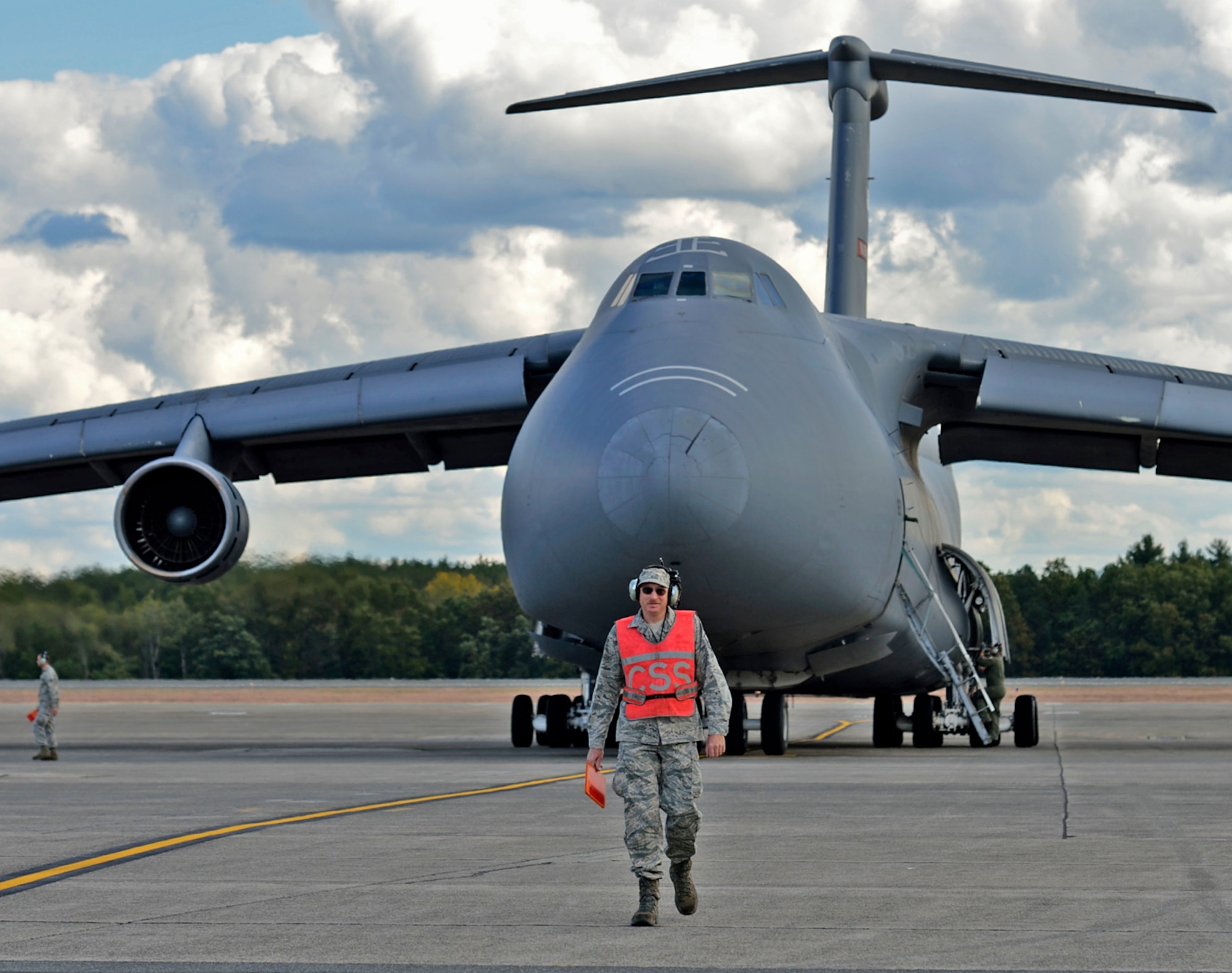 WESTOVER AIR RESERVE BASE, Mass. -- MSgt. Art Needham was given the
honor of marshalling "Miss Piggy" from its last parking spot here, for its flight to the "Bone Yard" at Davis-Monthan Air Force Base, Ariz. This C-5, tail number 0211, is an "A" model that has been stored here for over a year on the North Ramp with four others. Although this classic 1968 aircraft had a Martinsburg tail flash for its final flight, it was part of the Westover fleet years ago, and MSgt. Needham had served as its crew chief for 19 years. He nicknamed 0211 "Miss Piggy", which stuck, and as it lumbered into the sky for the last time, he said under his breath, "She served her country well." (Air Force photo by W.C.Pope)