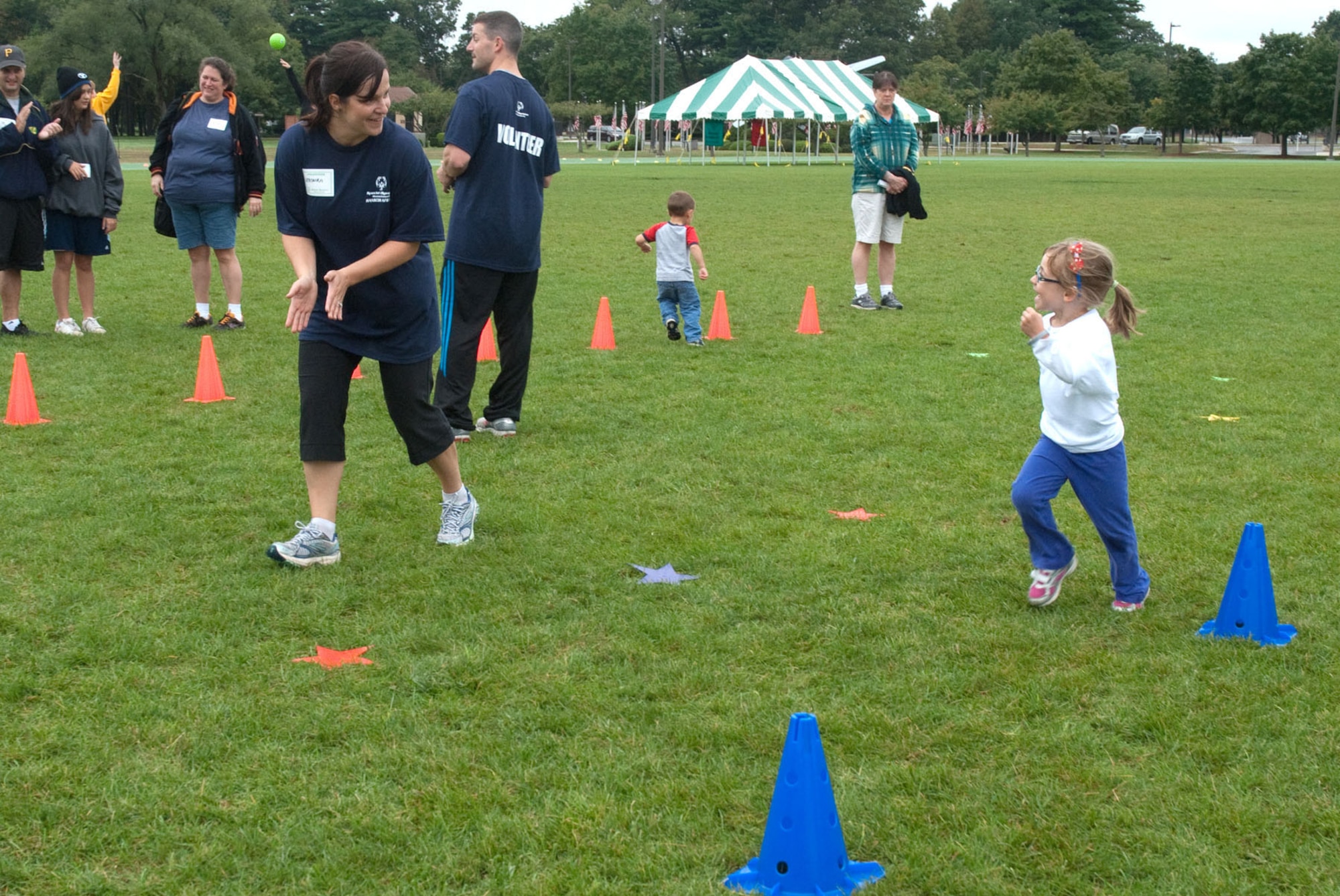 HANSCOM AIR FORCE BASE, Mass. – Veronika Archambault-Miliner, a volunteer at Hanscom's first Special Olympics event Sept. 22, cheers on five-year-old Catherine Seguin who was participating in some of the activities. In addition to the Special Olympics, a Special Needs Family Fun and Information Fair was held at Castle Park and included lunch, resource information booths and more. (U.S. Air Force photo by Mark Herlihy)