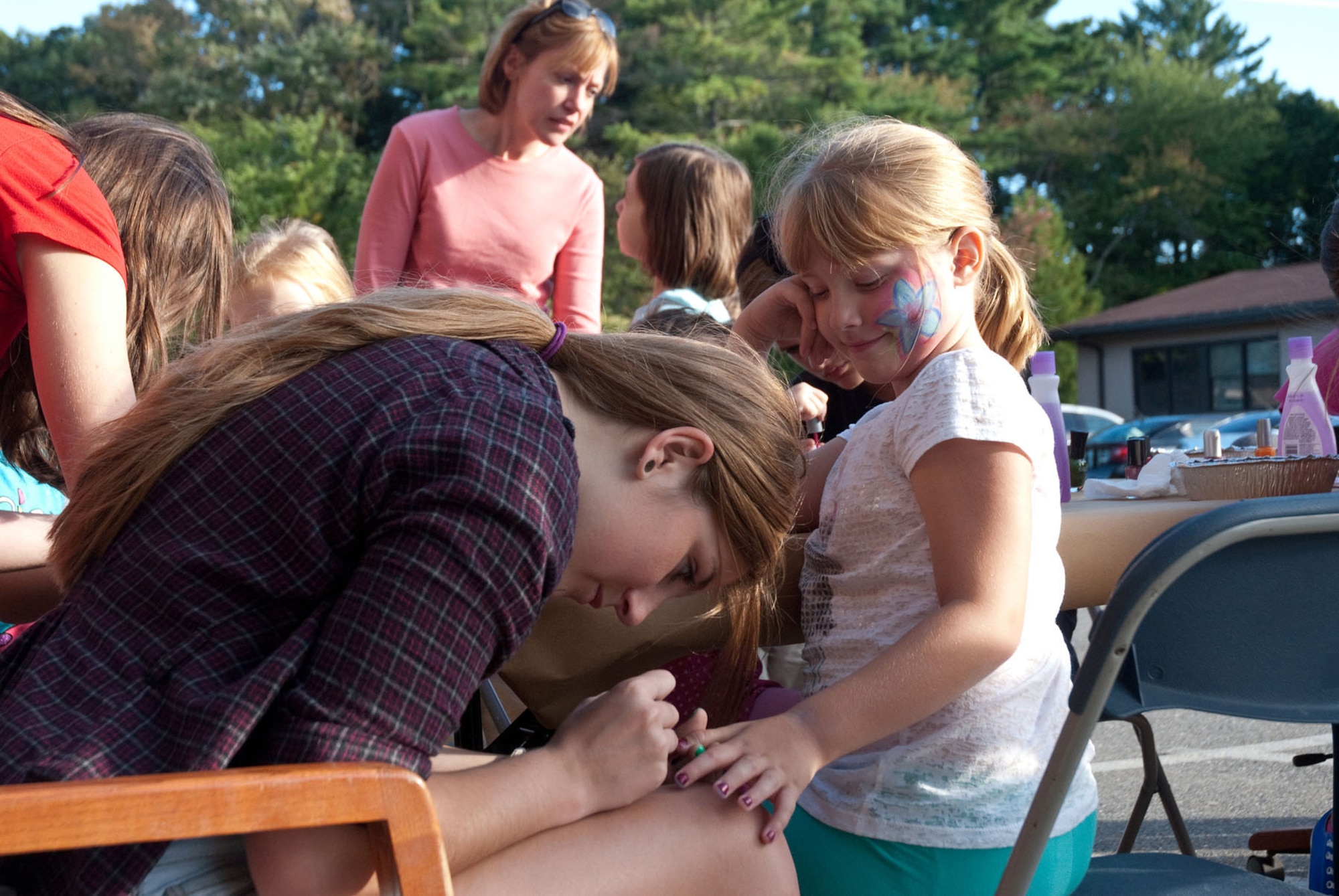 HANSCOM AIR FORCE BASE, Mass. – Taylor Leister paints Trinity Merring's nails during a Hearts Apart event on Sept. 19 at the Airman and Family Readiness Center. The A&FRC sponsored the event, which supports families of deployed, remote tour and extended TDY servicemembers. (U.S. Air Force photo by Mark Herlihy)