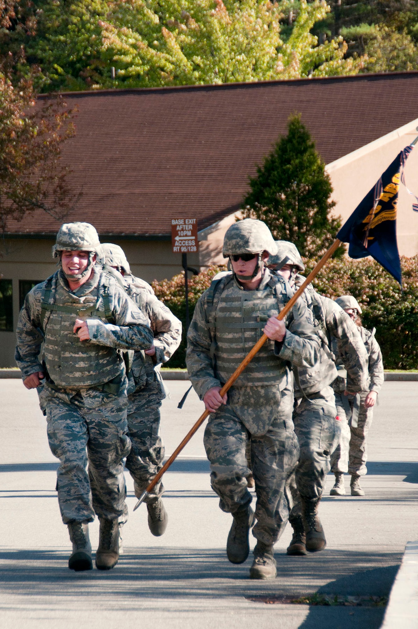 HANSCOM AIR FORCE BASE, Mass. -- Staff Sgt. John Twomey (left) and Senior Airman Morgan Glendenning lead members of the 66th Security Forces Squadron, who ran in full combat gear, as they approach the finish line near the Minuteman Commons during the Wounded Warrior Project 5K and 10K Sept. 19. The Company Grade Officers Council hosted the event, which raised more than $1,300 for the Wounded Warrior Project. (U.S. Air Force photo by Mark Wyatt)