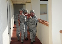 902nd security forces members perform a door- to- door search for additional active shooters during the Joint Base San Antonio-Randolph active shooter exercise Sept. 17 and 18. (U.S. Air Force photo by Don Lindsey)