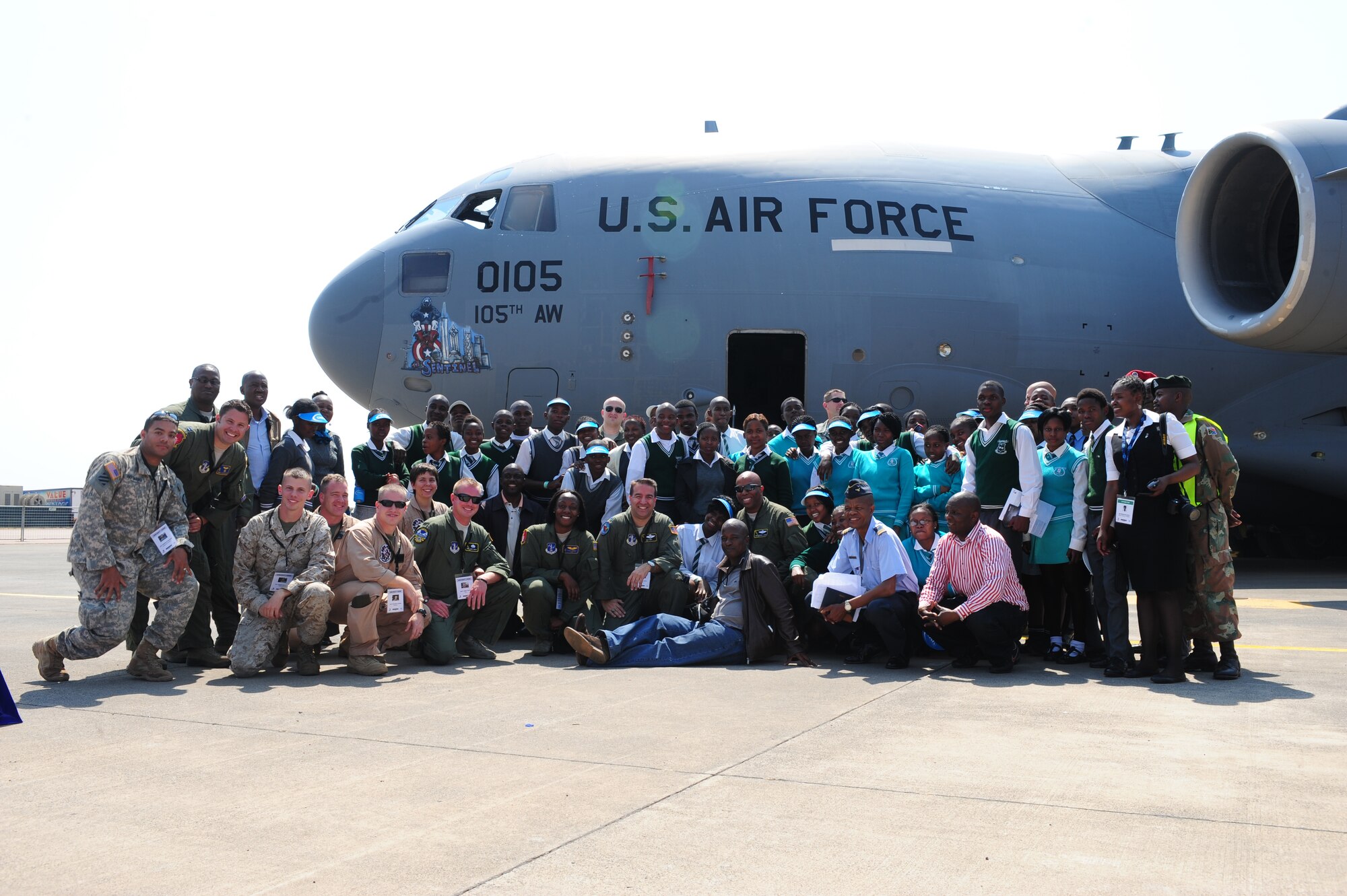 WATERKLOOF AIR FORCE BASE, South Africa -- Members of the U.S. military participating in the Africa Aerospace and Defense exposition pose for a picture in front of a C-17 Globe Master III with students from Jerusalem High School after a tour of a C-17 Globe Master III during the Youth Development Program event at the 2012 Africa Aerospace and Defense Exposition here, Sept. 21. For many of the children in attendance this was a once-in-a-lifetime opportunity to personally speak to pilots, engineers and other service members involved in aviation from both the South African military and the U.S. military. Partnering with this program gives the U.S. military means to enhance cooperation and capabilities with South Africa while helping to build up future generations here through education and awareness. (U.S. Air Force photo by Staff Sgt. Debbie Lockhart)
