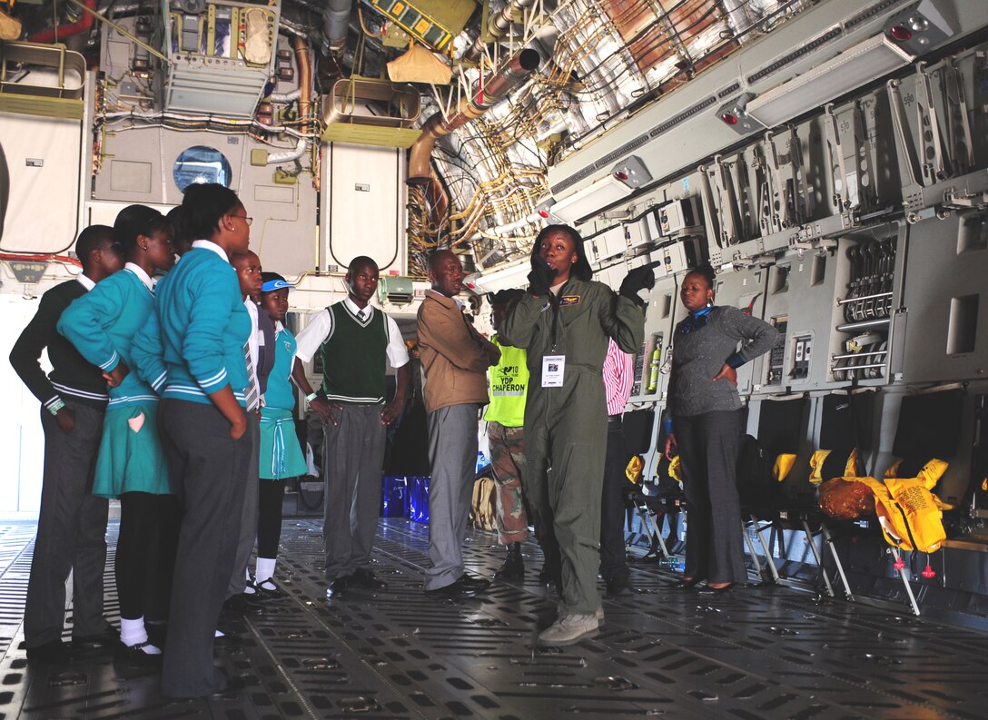 WATERKLOOF AIR FORCE BASE, South Africa -- Airman 1st Class Kyree Thomas, 137th Airlift Squadron loadmaster from Stewart Air National Guard base in Newburgh, New York, gives students from Jerusalem High School a tour of a C-17 Globe Master III during the Youth Development Program event at the 2012 Africa Aerospace and Defense Exposition here, Sept. 21. For many of the children in attendance this was a once-in-a-lifetime opportunity to personally speak to pilots, engineers and other service members involved in aviation from both the South African military and the U.S. military. Partnering with this program gives the U.S. military means to enhance cooperation and capabilities with South Africa while helping to build up future generations here through education and awareness. (U.S. Air Force photo by Staff Sgt. Debbie Lockhart)