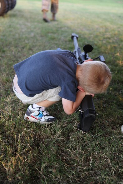Cade Blodzinski, son of U.S. Air Force 1st Lt. Ann Blodzinski, 20th Fighter Wing Chief of Public Affairs, and U.S. Air Force Capt. Jason Blodzinski, 77th Fighter Squadron F-16 Fighting Falcon pilot,checks out various weapons at simulated deployed location on Shaw Air Force Base, S.C. Sept. 19, 2012. Operation Take Flight gives children a chance to experience what processes their parents go through prior to deployments. (U.S. Air Force photo/1st Lt. Ann Blodzinski)(Released)

