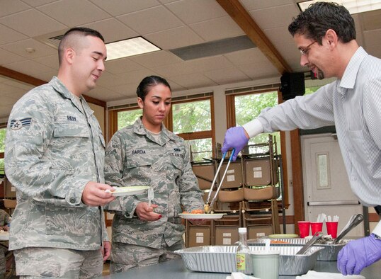 HANSCOM AIR FORCE BASE, Mass. - Senior Airman Richard Riley and Senior Airman Katherine Garcia, Airman Leadership School students, are served lunch by Luis Maggioli, La Casa De Pedro general manager, during the Hispanic Heritage Month Food Tasting at the Chapel Annex Sept. 21. La Casa De Pedro donated food for the event and will cater the Hispanic Heritage Month Luncheon scheduled for Oct. 11.  (U.S. Air Force photo by Mark Wyatt)