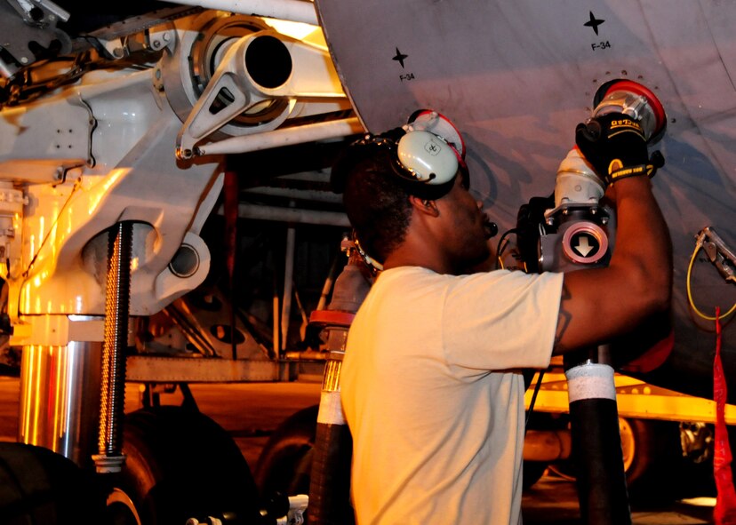 ANDERSEN AIR FORCE BASE, Guam – Staff Sgt. Kiwan Edwards, 734th Air Mobility Squadron crew chief, removes the fuel hose after defueling a C-5 Galaxy prior to conducting maintenance on the aircraft here, Sept. 11. The C-5 Galaxy was carrying cargo in support of Exercise Valiant Shield 2012. The 734th AMS maintenance flight manages all en route maintenance production activities. The C-5 Galaxy carried cargo in support of Exercise Valiant Shield 2012. (U.S. Air Force photo by Airman 1st Class Marianique Santos/Released)