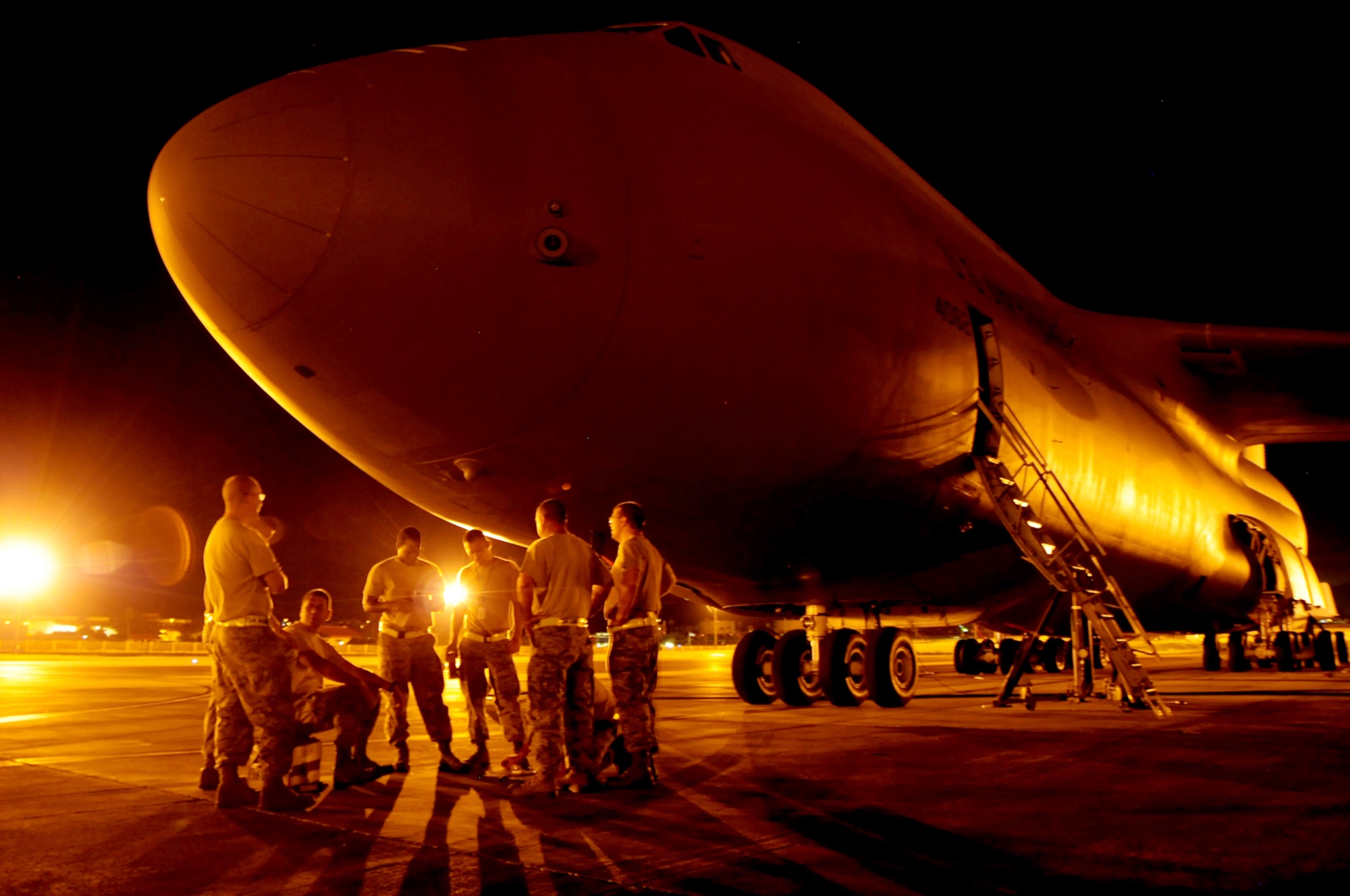ANDERSEN AIR FORCE BASE, Guam – Airmen from the 734th Air Mobility Squadron maintenance team gather and discuss the plan of action in using aircraft jacks to lift a C-5 Galaxy on the flightline here, Sept. 11. The 734th AMS maintenance flight manages all en route maintenance production activities. The C-5 Galaxy carried cargo in support of Exercise Valiant Shield 2012. (U.S. Air Force photo by Airman 1st Class Marianique Santos/Released)