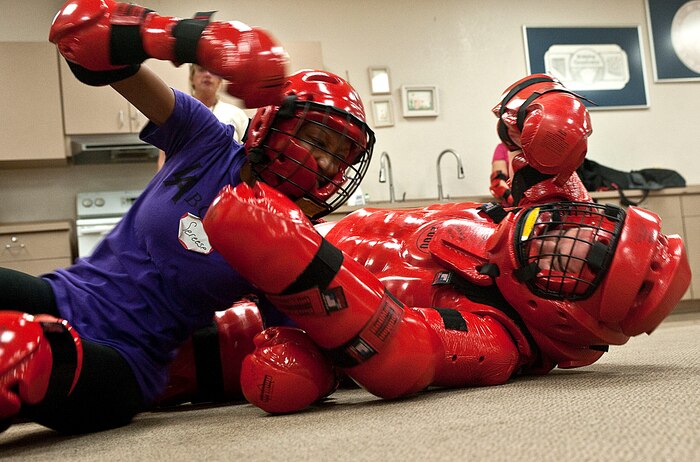 Staff Sgt. Sereese Davis, 99th Air Base Wing command post controller, defends against Staff Sgt. Brandon Kilfoyle, 99th ABW chaplain assistant, during a Rape Aggression Defense Systems class Sept. 18, 2012, at Nellis Air Force Base, Nev. To become certified, 10 Airmen were evaluated in areas to include a practical test, written test, and a simulation exercise. (U.S. Air Force photo by Staff Sgt. Christopher Hubenthal)

