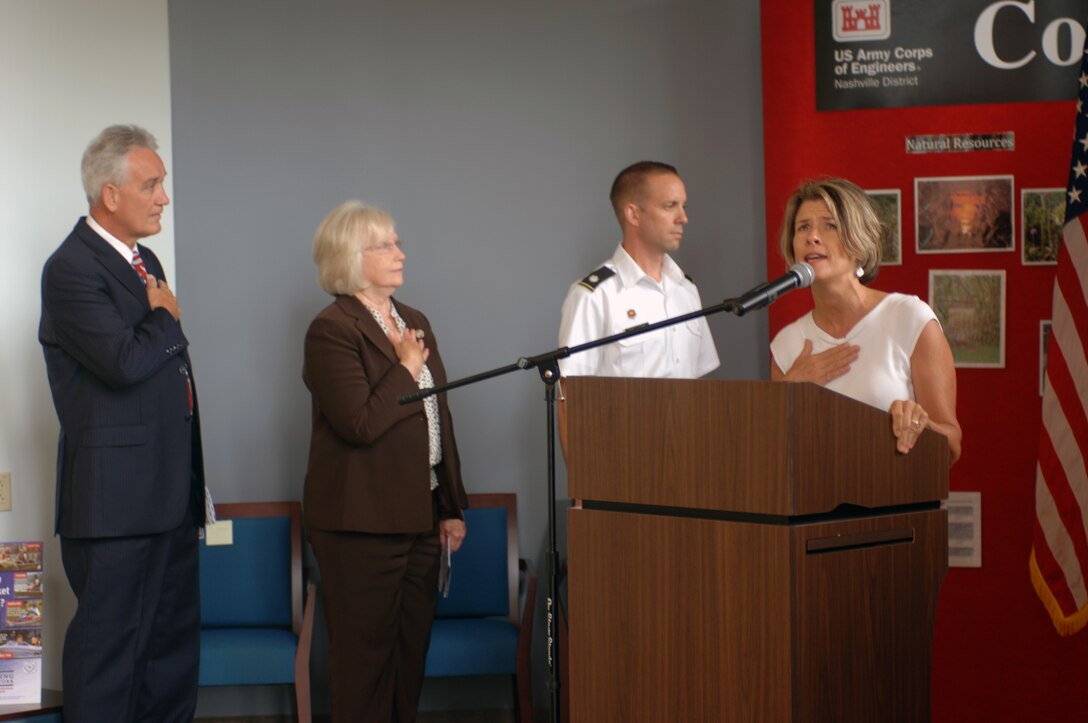 Tennessee State Representative Terri Lynn Weaver begins the ceremony at Cordell Hull's new Visitor's Center and Resource Manager's Office July 20, 2012 singing the National Anthem. Representative Weaver represents Tennessee State District 40. From Left to right in the background are Commissioner Bill Woodard, State Senator Mae Beavers, and Nashville District Commander Lt. Col. James A. DeLapp. (USACE photo by Michael Rivera)