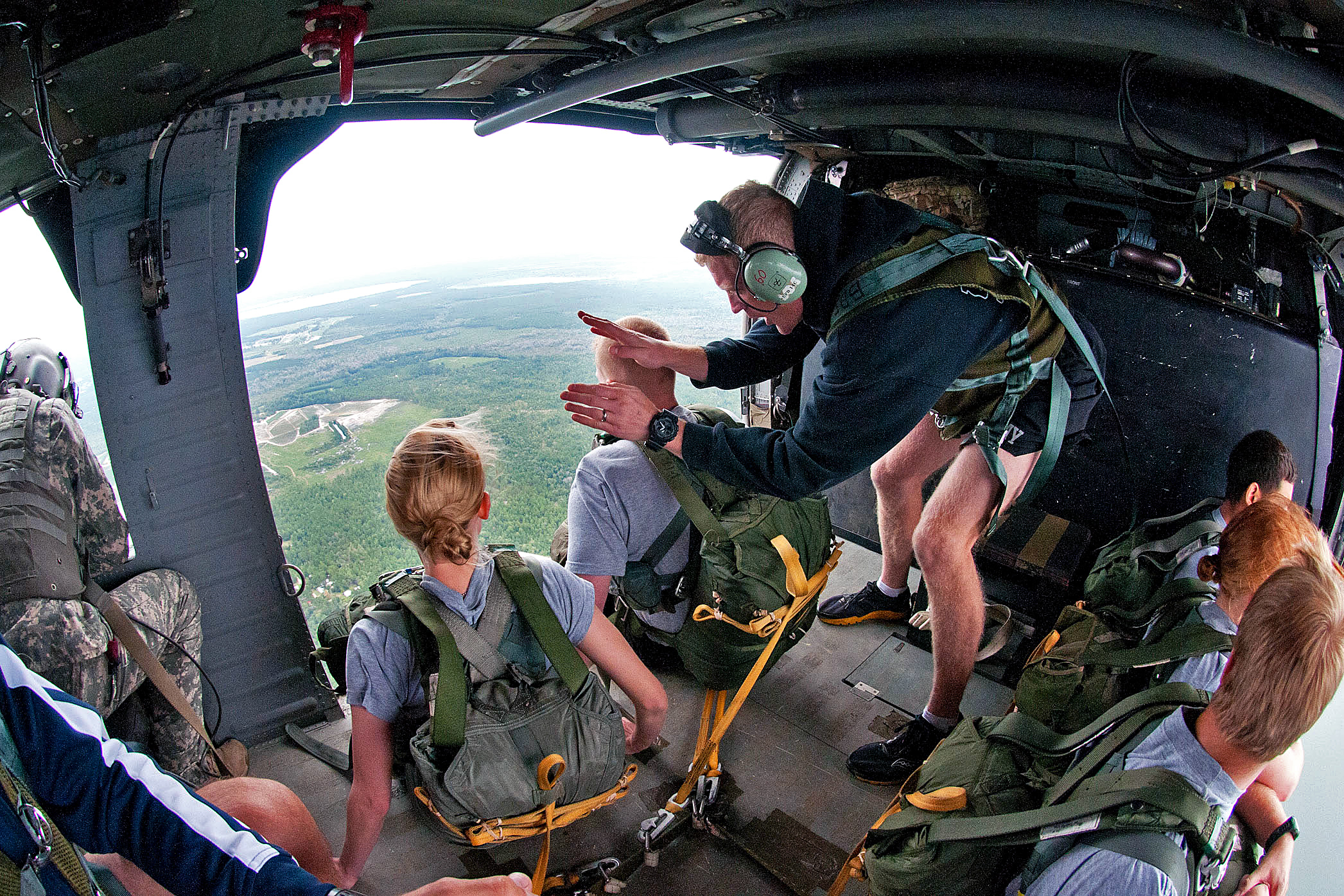 A U.S. Army jumpmaster slaps a paratrooper on the shoulder, signaling