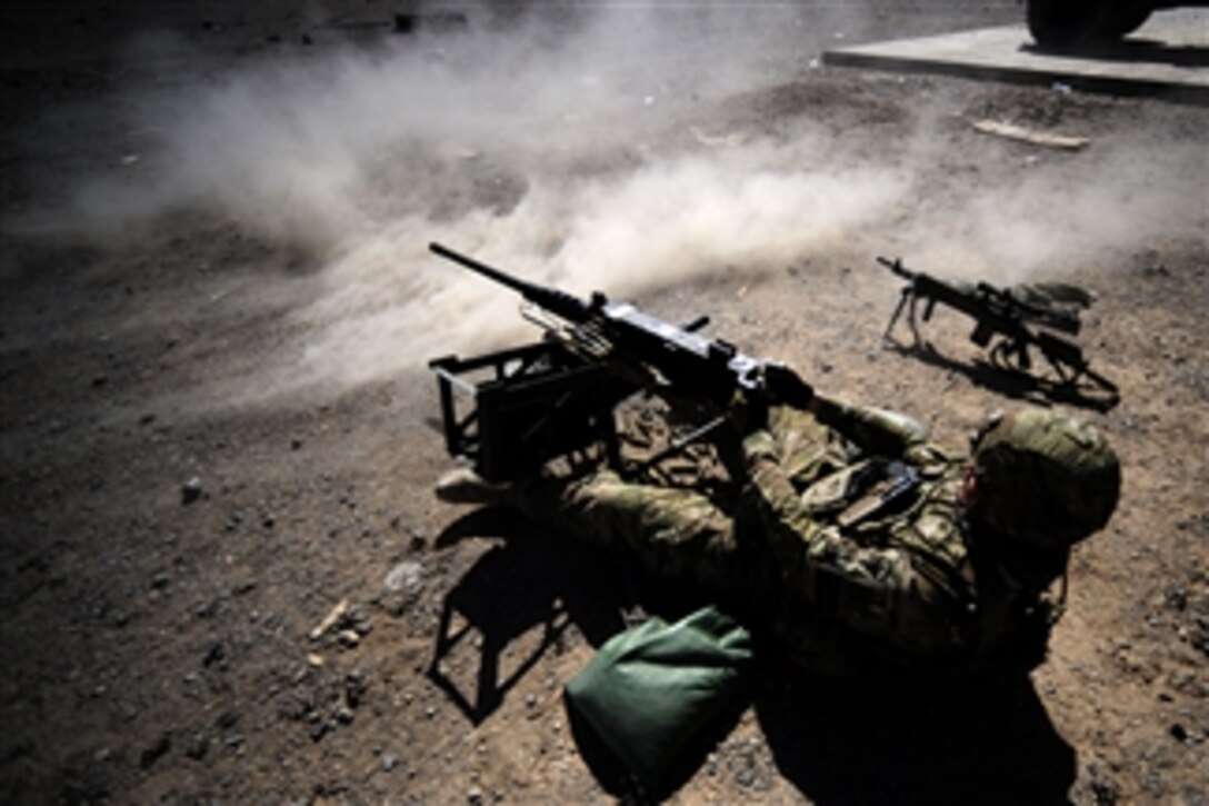 U.S. Navy Chief Petty Officer Joshua Oswald engages targets with an M2 .50-caliber machine gun during training at the long range on Forward Operating Base Farah in the Farah province of Afghanistan on Sept. 22, 2012.  Oswald is attached to the Farah Provincial Reconstruction Team.  