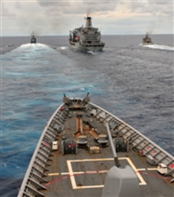 The guided missile cruiser USS Anzio (CG 68), foreground, approaches the replenishment oiler USNS Patuxent (T-AO 201), center, during a replenishment at sea exercise in the Straits of Florida on Sept. 23, 2012.  The Anzio and Patuxent are maneuvering with the Colombian navy frigate ARC Antioquia (FM 53) and Mexican offshore patrol vessel ARM Independencia (P-163) as part of multinational naval exercise Unitas Atlantic 2012.  The exercise is designed to enhance security cooperation and improve coalition operations between South American and U.S. maritime forces.  