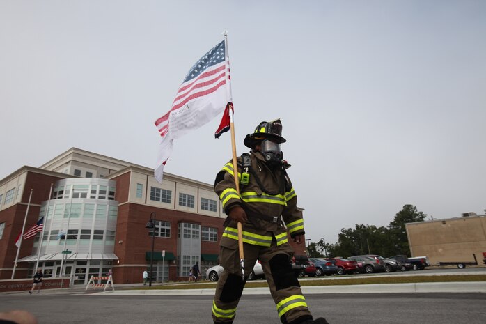 A Marine Corps Base Camp Lejeune firefighter vowed to complete the 5k run in full firefighter gear. He carried the American flag as a sign of respect for those lost on 9/ll.
