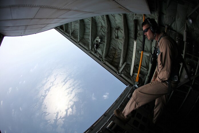 Cpl. Blaise Conway, a KC-130J load master, and Arlington, Tenn., native with Marine Aerial Refueler Transport Squadron 252,  Marine Medium Tiltrotor Squadron 261 (Reinforced), 24th Marine Expeditionary Unit, looks out the back of a KC-130J Hercules during an aerial refueling training operation Sep. 23, 2012. The training consisted of MV-22B Ospreys and AV-8B Harriers with the 24th MEU conducting aerial refueling with the 24th MEU's KC-130J Hercules planes to practice the skills needed for long-range flight operations. The 24th MEU is deployed with the Iwo Jima Amphibious Ready Group as a theater reserve and crisis response force for U.S. Central Command in the U.S. Navy's 5th Fleet area of responsibility.