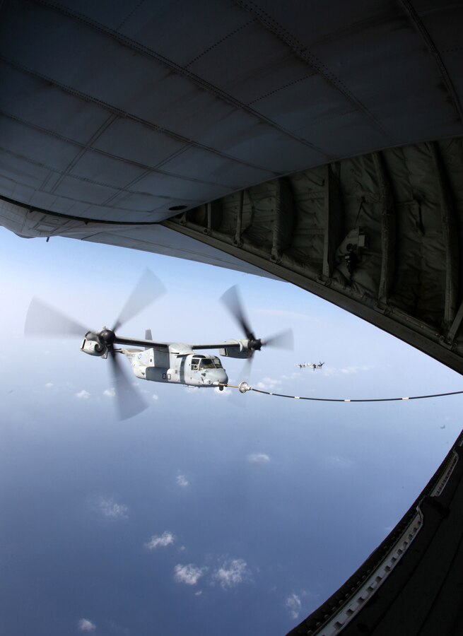 An MV-22B Osprey connects to the refueling hose of a KC-130J Hercules, during aerial refueling training Sept. 23, 2012. Both aircraft are with Marine Medium Tiltrotor Squadron 261 (Reinforced), 24th Marine Expeditionary Unit, and conducted aerial refueling training to practice the skills needed for long-range flight operations. The 24th MEU is deployed with the Iwo Jima Amphibious Ready Group as a theater reserve and crisis response force for U.S. Central Command in the U.S. Navy's 5th Fleet area of responsibility.