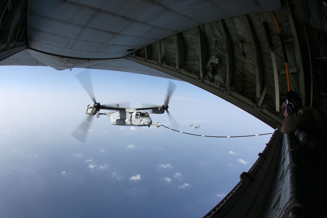 Cpl. Blaise Conway, a KC-130J load master, and Arlington, Tenn., native with Marine Aerial Refueler Transport Squadron 252, Marine Medium Tiltrotor Squadron 261 (reinforced), 24th Marine Expeditionary Unit, looks out the back of a KC-130J Hercules as an MV-22B Osprey is refueled during a training mission Sep. 23, 2012. The training consisted of MV-22B Ospreys and AV-8B Harriers from the 24th MEU conducting aerial refueling with the 24th MEU's KC-130J Hercules planes to practice the skills needed for long-range flight operations.  The 24th MEU is deployed with the Iwo Jima Amphibious Ready Group as a theater reserve and crisis response force for U.S. Central Command in the U.S. Navy's 5th Fleet area of responsibility.