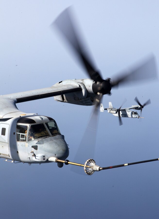 An MV-22B Osprey connects to the refueling hose of a KC-130J Hercules, during aerial refueling training Sept. 23, 2012. Both aircraft are with Marine Medium Tiltrotor Squadron 261 (Reinforced), the aviation combat element for the 24th Marine Expeditionary Unit, and conducted aerial refueling training to practice the skills needed for long-range flight operations. The 24th MEU is deployed with the Iwo Jima Amphibious Ready Group as a theater reserve and crisis response force for U.S. Central Command in the U.S. Navy's 5th Fleet area of responsibility.