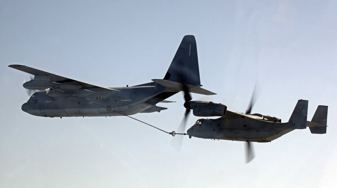 An MV-22B Osprey, right, and a KC-130J Hercules, both with Marine Medium Tiltrotor Squadron 261 (Reinforced), 24th Marine Expeditionary Unit, conduct aerial refueling training operations, Sept 23, 2012. The training consisted of MV-22B Ospreys and AV-8B Harriers conducting aerial refueling with the 24th MEU's KC-130J Hercules planes to practice the skills needed for long-range flight operations.  The 24th MEU is deployed with the Iwo Jima Amphibious Ready Group as a theater reserve and crisis response force for U.S. Central Command in the U.S. Navy's 5th Fleet area of responsibility.