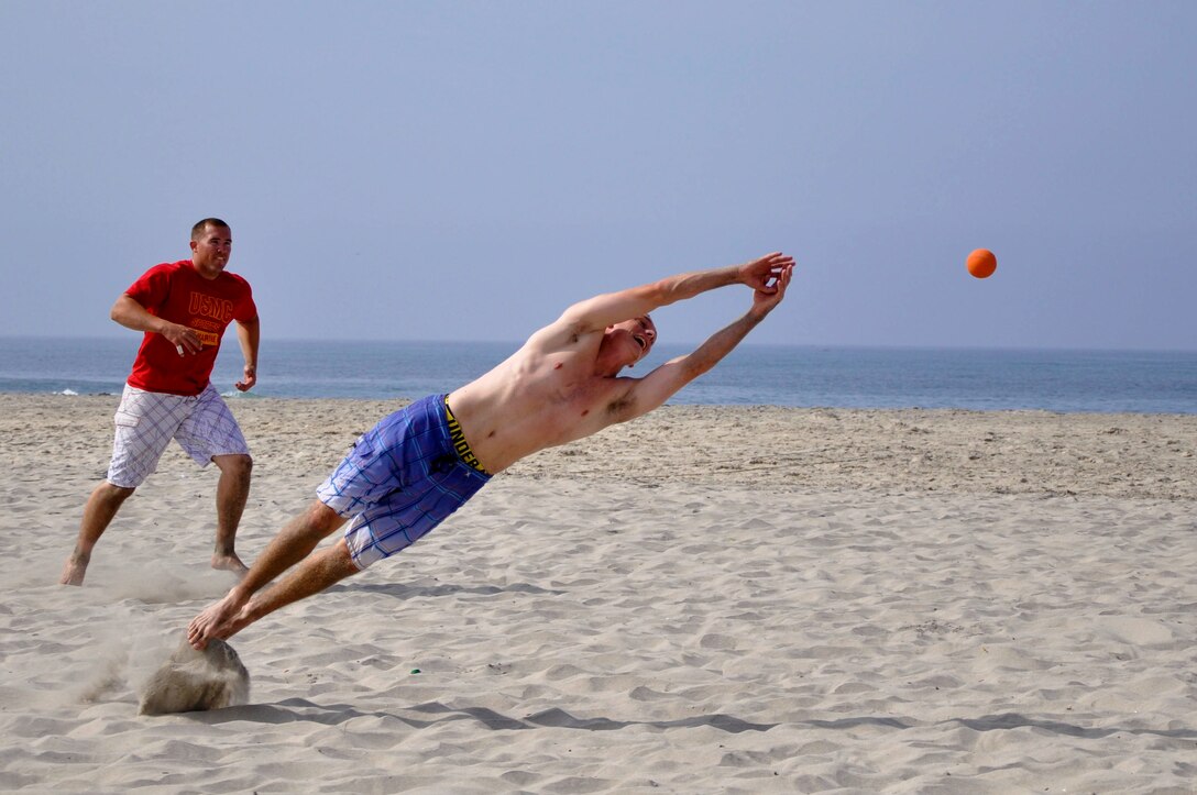Members of the team "Drunk and Disorderly" attempt to catch a fly ball during the first round of Camp Pendleton's Over-the-Line tournament at the Del Mar Beach, Sept. 22. Any ball hit into fair-territory without being caught by fielders is considered a "hit" in OTL.