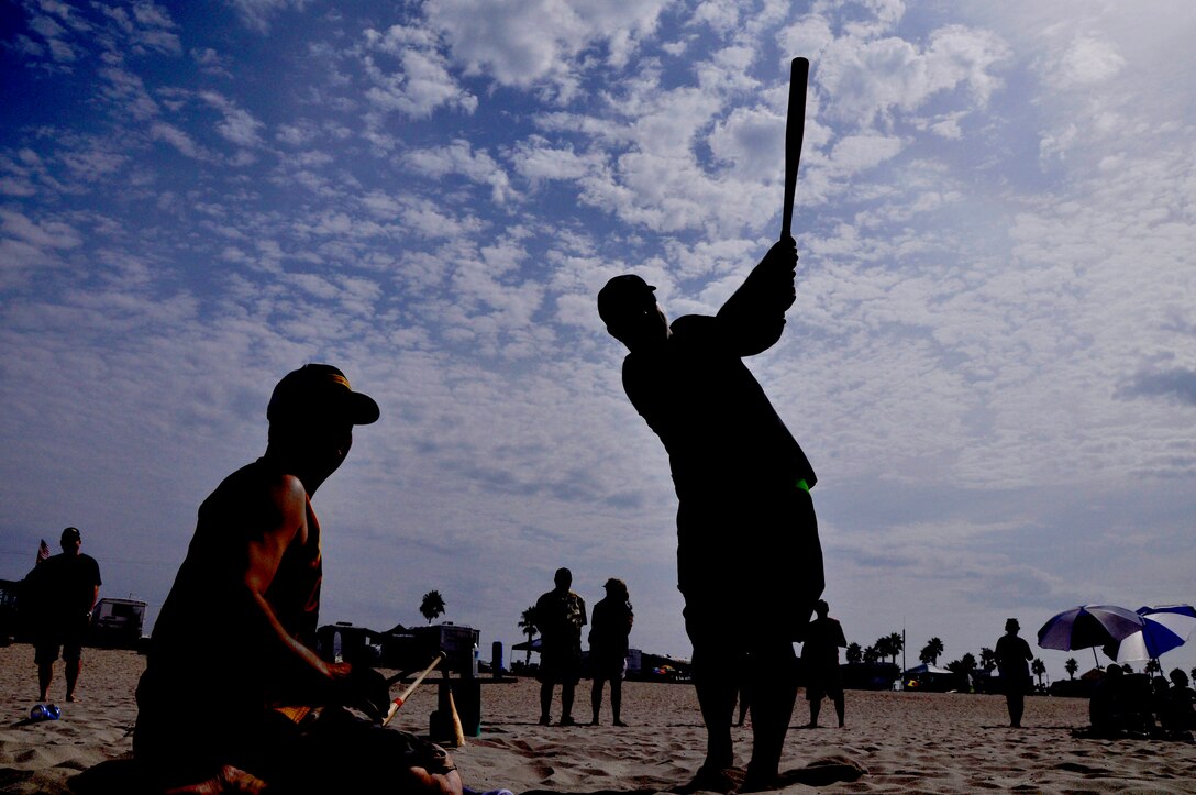 A pitcher and batter assist each other during their turn up to bat during Camp Pendleton's Over-the-Line tournament at the Del Mar Beach, Sept. 22. The tournament served as a pilot event to potentially have the sport incorporated into the Pendleton Cup Series beginning next year.
