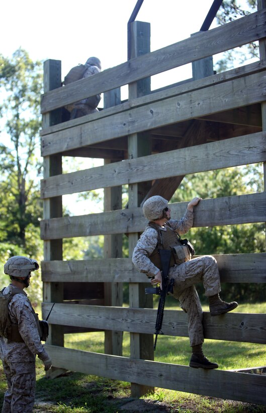 Lance Cpl. Kaley Mitchell, a bulk fuel specialist with 8th Engineer Support Battalion, 2nd Marine Logistics Group, climbs over an obstacle during movement-to-contact training aboard Camp Lejeune, N.C., Sept. 25, 2012. The purpose of the training was to promote teamwork and combat marksmanship.