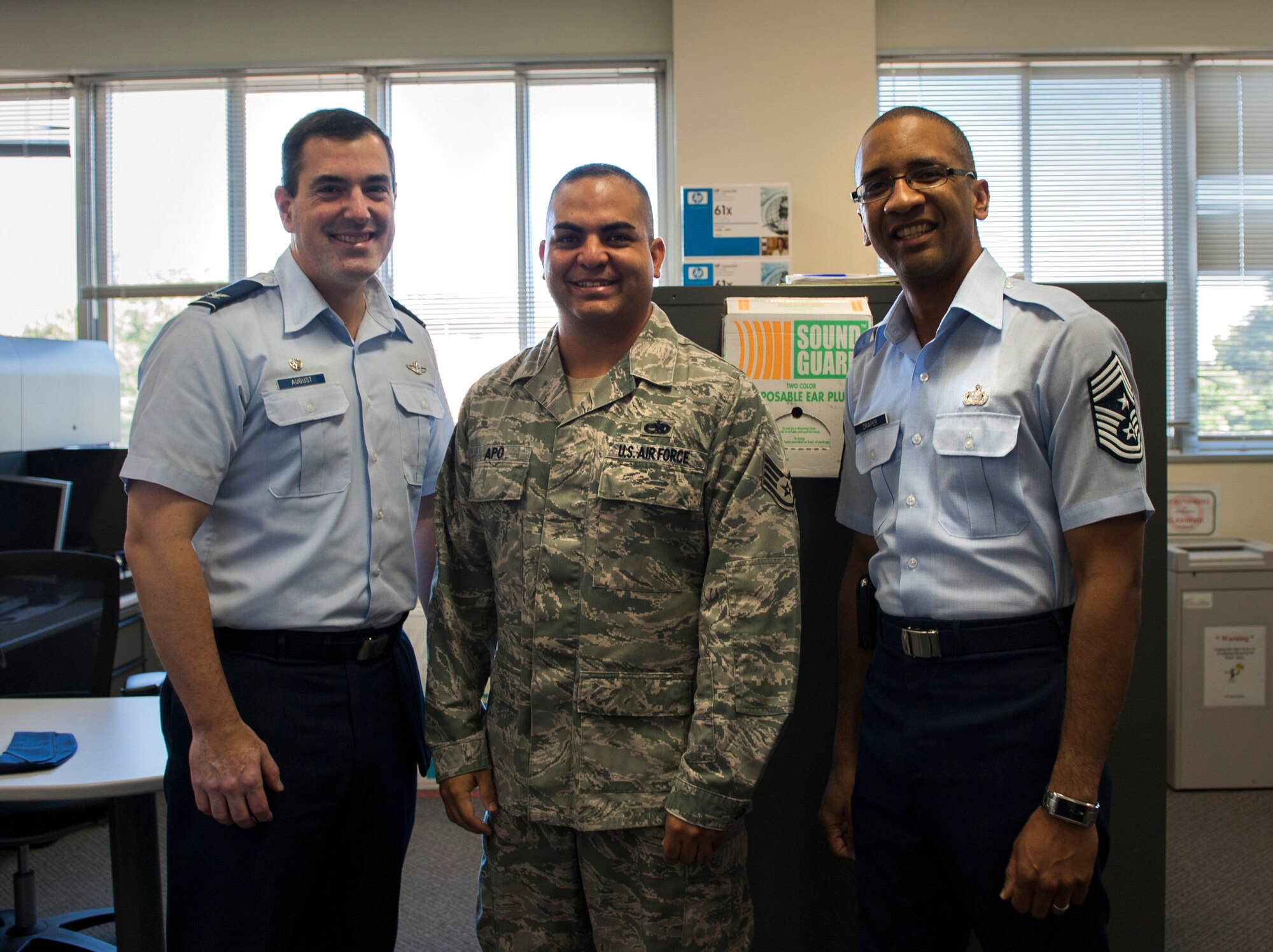 YOKOTA AIR BASE, Japan -- Staff Sgt. Galen Apo, 374th Maintenance Group quality assurance inspector, center, stands with Col. Mark August, 374th Airlift Wing commander, left, and Chief Master Sgt. Ronald Draper, 374th AW command chief at Yokota Air Base, Japan, Sept. 24, 2012. Apo was recognized for his selection to attend Officer Training School out of 507 applications throughout the U.S. (U.S. Air Force photo by Airman 1st Class Krystal M. Garrett)