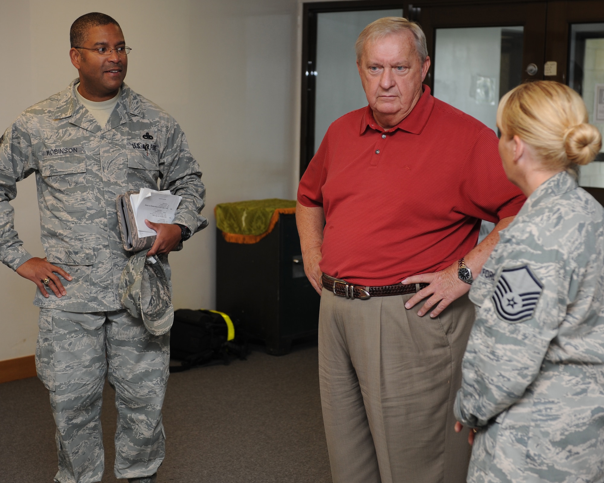 Former Chief Master Sgt. of the Air Force James Binnicker (center) speaks with Master Sgt. Jessica Woodruff, 8th Force Support Squadron enlisted career advisor, and Chief Master Sgt. Phillip Robinson, 8th Fighter Wing command chief, about the First Term Airmen Center during a tour of Kunsan Air Base, Republic of Korea, Sept. 19, 2012. Binnicker, who was CMSAF from 1986 to 1990, took the opportunity to speak with and learn about the challenges faced by Airmen currently stationed at Kunsan. (U.S. Air Force photo/Staff Sgt. Jonathan Fowler)