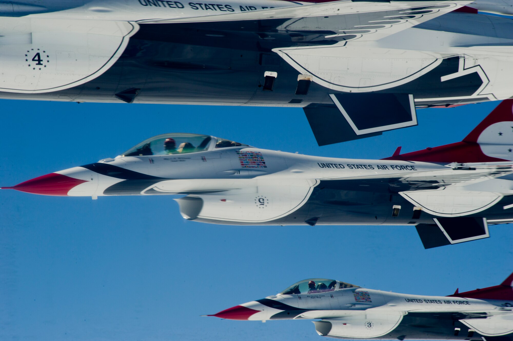 The U.S. Air Force Thunderbirds F-16 demonstration squadron flies in formation alongside a KC-135 Stratotanker from McConnell Air Force Base, Kan., during a refueling mission, Sept. 27, 2012.  An aircrew from McConnell's 22nd Air Refueling Wing refueled the Thunderbirds as they were in route to McConnell for the base's "Wings Over McConnell" air show.  Several members of the McConnell Honorary Commander program rode along on the refueling mission.  (U.S. Air Force photo by Senior Airman Armando A. Schweir-Morales)