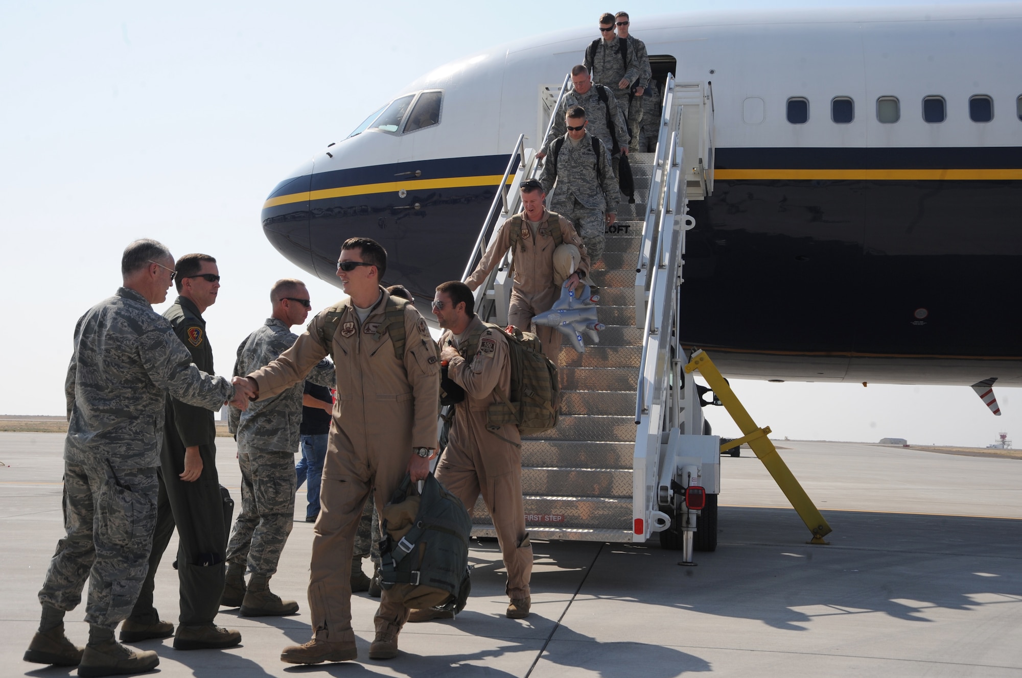 Airmen from the 366th Fighter Wing disembark from the aircraft and shake hands with senior base leaders after a six-month deployment to Southwest Asia Sept. 27 at Mountain Home Air Force Base, Idaho. The 391st Fighter Squadron and 366th Aircraft Maintenance Squadron executed Combined Forces Air Component Command priorities, took advantage of training opportunities to impart valuable knowledge to host nation partners and bolstered regional security. (U.S. Air Force photo/Senior Airman Benjamin Sutton) 