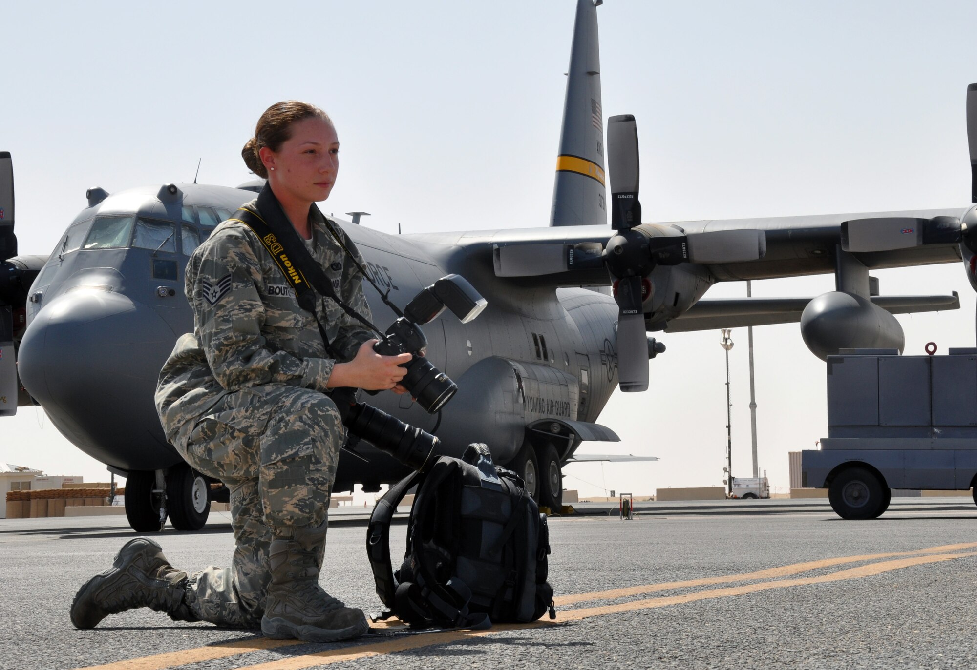 Staff Sgt. Alexandra Boutte, 386th Air Expeditionary Wing Public Affairs, prepares to photograph activity on the flightline. Sergeant Boutte’s job is telling the stories of other service members through photography, both stateside and on the frontlines. She is a photojournalist deployed from the 509th Bomb Wing Public Affairs office. (U.S. Air Force photo/ Master Sgt. Kristina Barrett) (RELEASED)