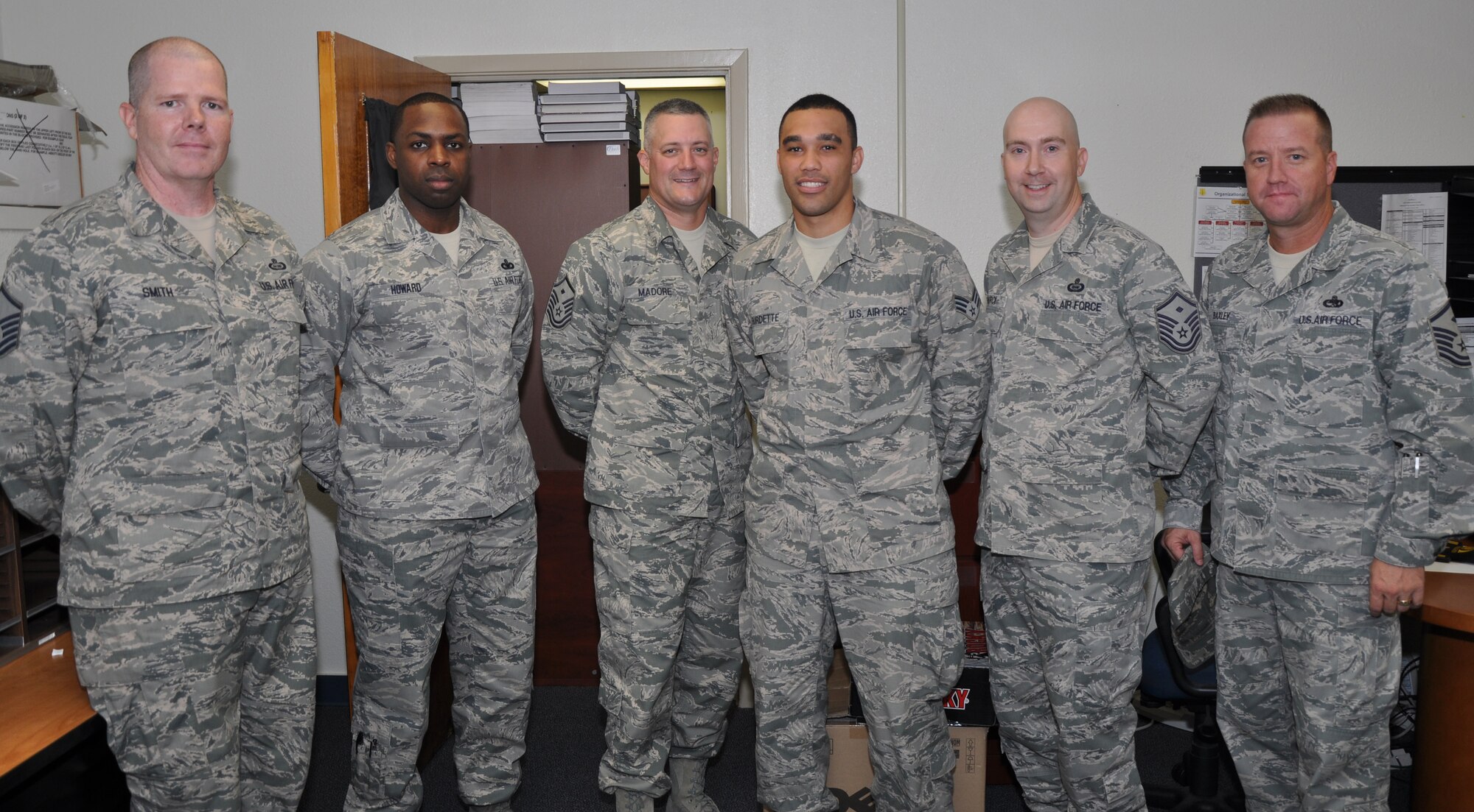 GOODFELLOW AIR FORCE BASE, Texas- Left, Master Sgt. Christopher Smith, 17th Training Support Squadron first sergeant, Master Sgt. Christopher Howard, 17th Communication Squadron first sergeant, Master Sgt. Chad Madore, 316th Training Squadron first sergeant, Senior Airman Jamie Burdette, 17th Force Support Squadron formal training and career development, Master Sgt. Christopher Norci, Force Support Squadron first sergeant, and Master Sgt. James Baxley, 17th Medical Group first sergeant, gather for the Diamond Sharp Award in the Education Office, Sept. 27. The first sergeants agreed that Senior Airman Burdette should receive the award. (Photo by Airman 1st Class Joshua D. Edwards/Released) 