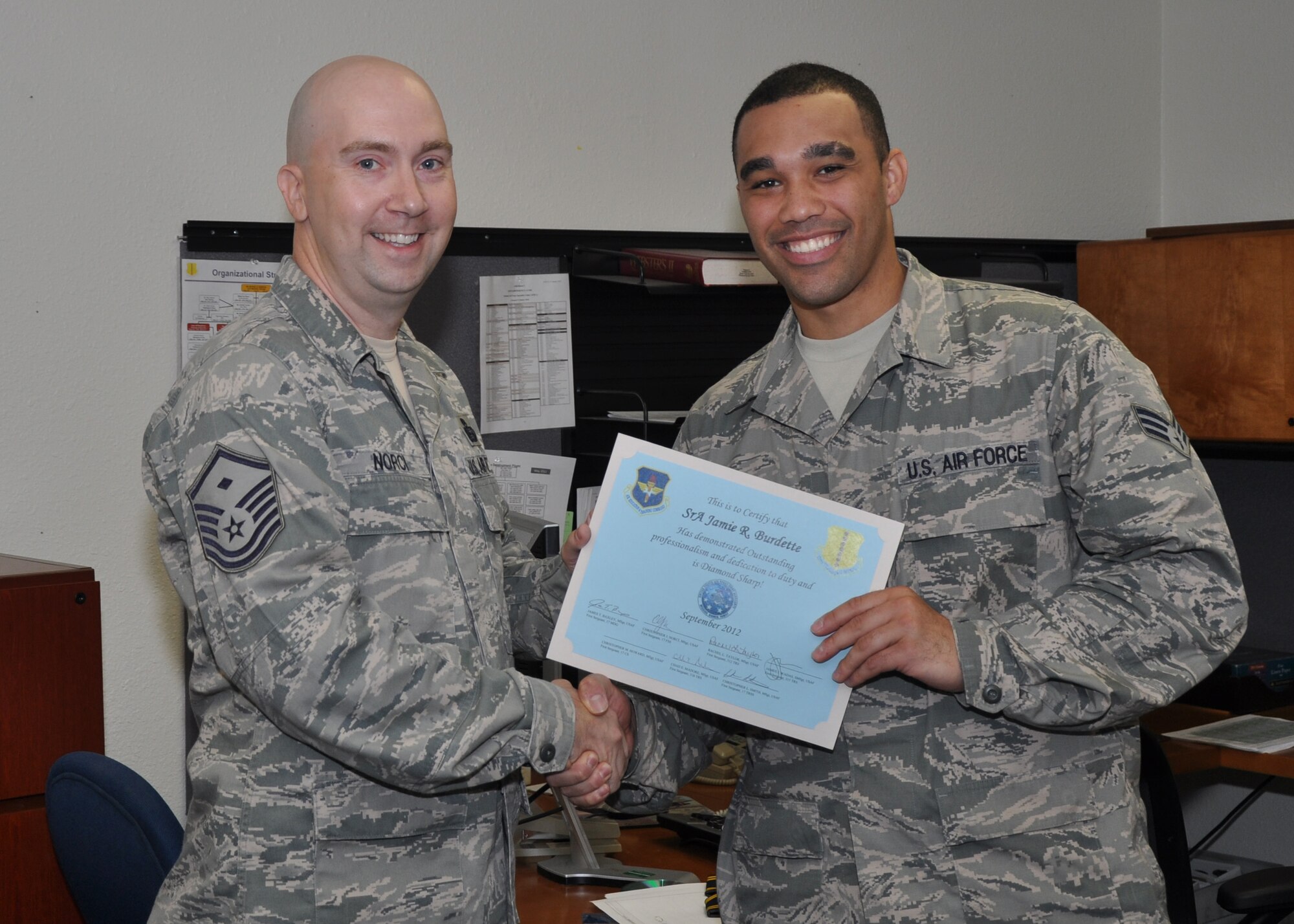 GOODFELLOW AIR FORCE BASE, Texas- Senior Airman Jamie Burdette, 17th Force Support Squadron formal training and career development, receives the Diamond Sharp Award from Master Sgt. Christopher Norci, 17th Force Support Squadron first sergeant, at the Education Office, Sept. 27. Master Sgt. Norci said Senior Airman Burdette received the award for his continued exemplary service. (Photo by Airman 1st Class Joshua D. Edwards/Released)