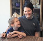 Airman Basic Shelby Goff sits with her 6-year-old brother, Amadeaus Foster, at their home in Grand Junction, Colo. (Courtesy photo, Dean Humphrey, The Daily Sentinel)