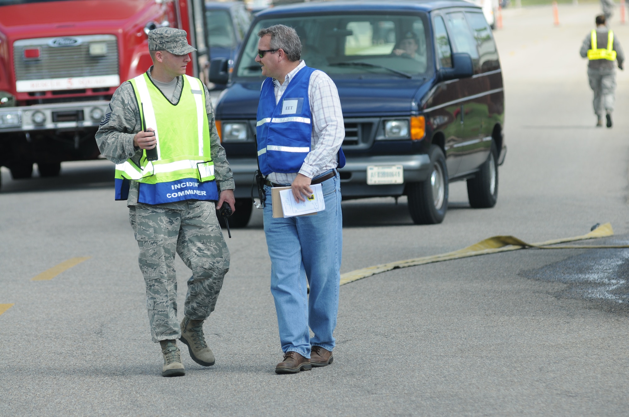 Master Sgt. Danyiel Blankenship, Keesler firefighter, discusses the exercise scenario with Thane Halsey, 81st Training Wing installation exercise program chief, while on scene during a hazardous material exercise Sept. 27, 2012, at Keesler Air Force Base, Miss.  In the scenario a routine delivery flatbed trailer transporting hazardous material is struck by a van transporting Airmen causing one of the containers to fall from the vehicle and rupture. The exercise helped prepare first responders in the event of a real-world incident.  (U.S. Air Force photo by Kemberly Groue)