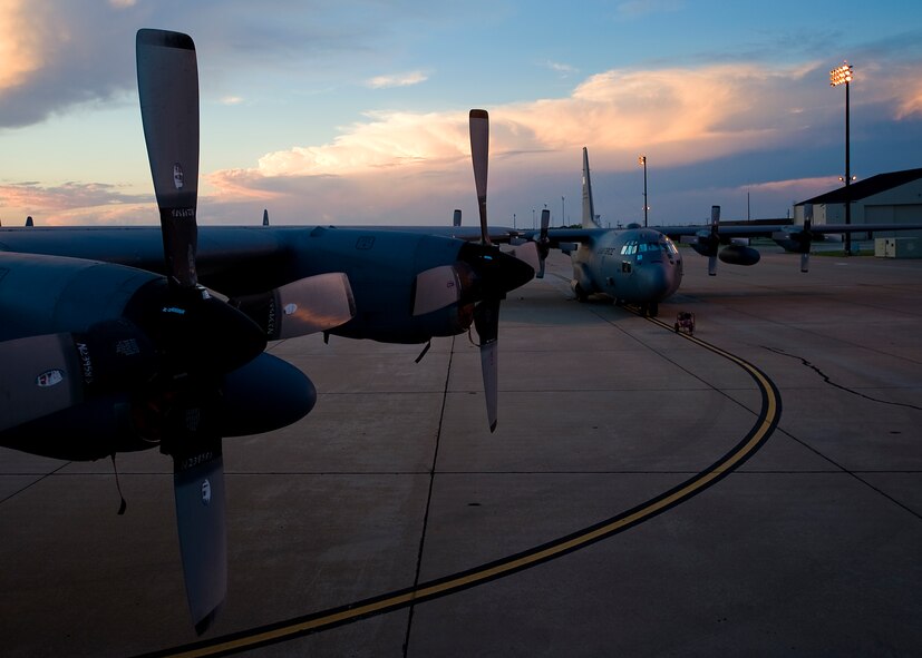Two C-130 Hercules sit on the flight line as the Texas sun sets behind them for the last time Sept. 25, 2012, at Dyess Air Force Base, Texas. For 37 years Dyess’ C-130 Hercules and its Airmen have built a legacy in the Air Force. That legacy came to end Sept. 26 as the last two C-130 H models, tail numbers 1667 and 2063, departed for Little Rock AFB, Ark.  (U.S. Air Force photo by Airman 1st Class Damon Kasberg/ Released)