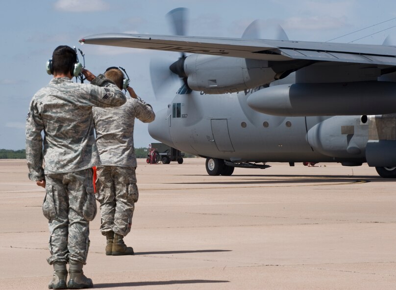 Airmen from the 317th Airlift Group salute the last departing C-130 Hercules Sept. 26, 2012, at Dyess Air Force Base, Texas. For 37 years Dyess’ C-130 Hercules and its Airmen have built a legacy in the Air Force. That legacy came to end Sept. 26 as the last two C-130H models, tail numbers 1667 and 2063, departed for Little Rock AFB, Ark. (U.S. Air Force photo by Airman 1st Class Jonathan Stefanko/ Released)