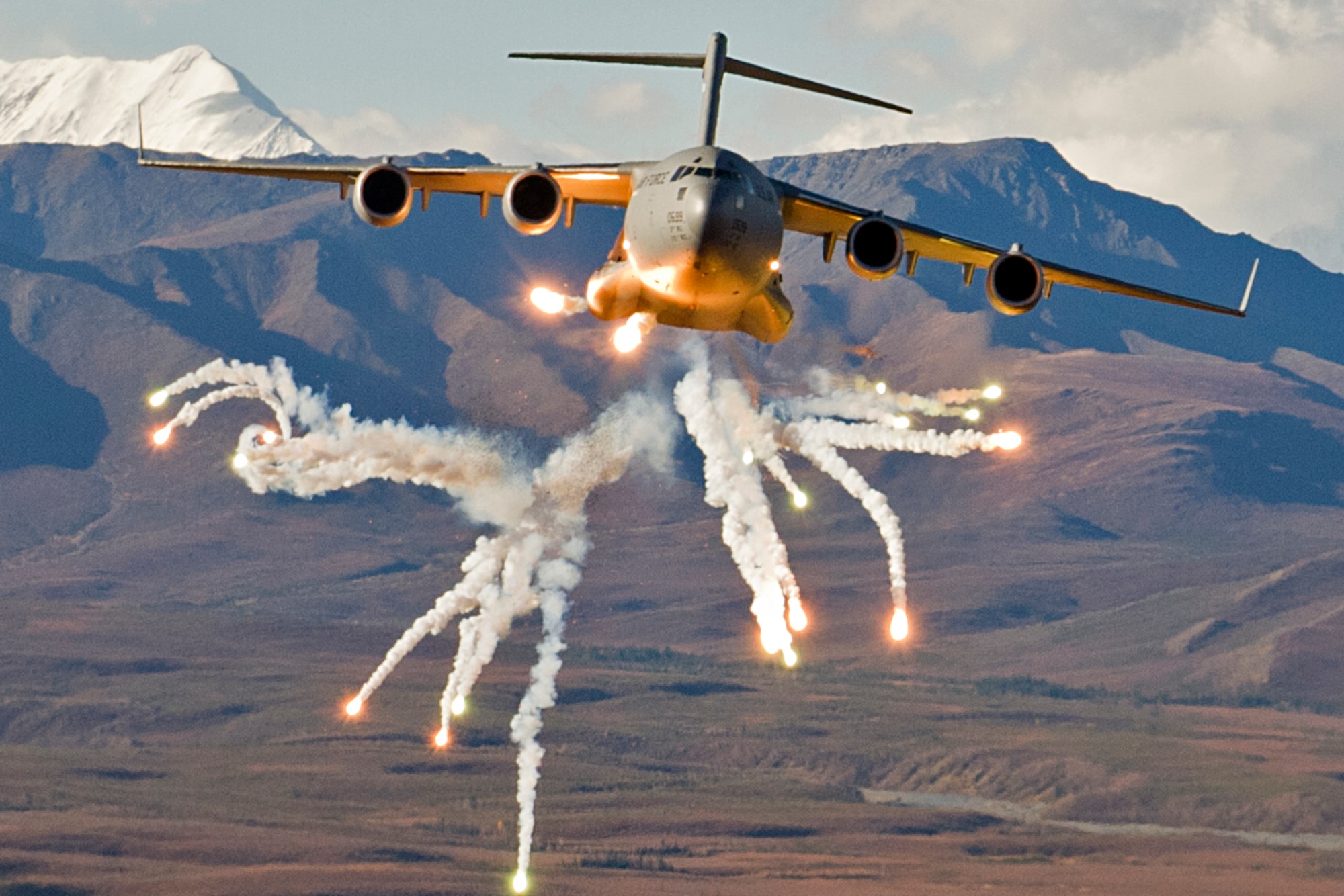 A C-17 Globemaster III cargo plane sets off flares during the 3rd Wing "war day," Sept. 21, 2012. The Discovery Channel is going to feature the C-17 on a future episode of "Mighty Planes" and was here on Joint Base Elemendorf-Richardson filming. (U.S. Air Force photo/Staff Sgt. Zachary Wolf)