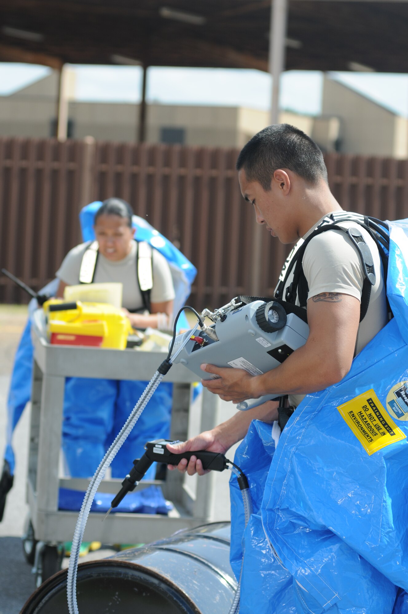 Senior Airman Sheila Jones, and Airman Von Carios, 81st Aerospace Medicine Squadron, determine what kind of chemical spilled at the scene of the “accident”  during a hazardous material exercise Sept. 27, 2012, at Keesler Air Force Base, Miss.  In the scenario a routine delivery flatbed trailer transporting hazardous material is struck by a van transporting Airmen causing one of the containers to fall from the vehicle and rupture. The exercise helped prepare first responders in the event of a real-world incident.  (U.S. Air Force photo by Kemberly Groue)