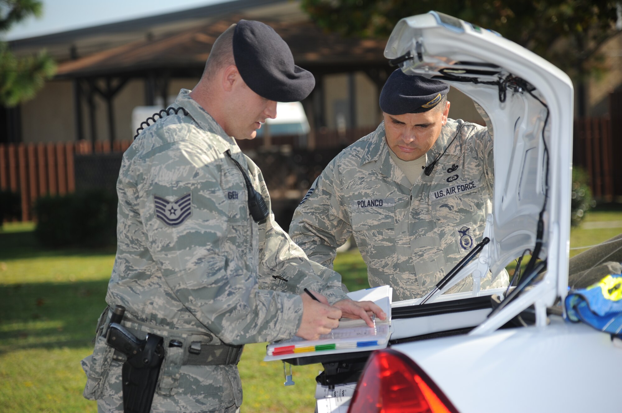 Tech. Sgt. Brandon Geeslin and Master Sgt. Robert Polanco, 81st Security Forces Squadron, survey the cordon area around the accident scene during a hazardous material exercise Sept. 27, 2012, at Keesler Air Force Base, Miss.  In the scenario a routine delivery flatbed trailer transporting hazardous material is struck by a van transporting Airmen causing one of the containers to fall from the vehicle and rupture. The exercise helped prepare first responders in the event of a real-world incident.  (U.S. Air Force photo by Kemberly Groue)