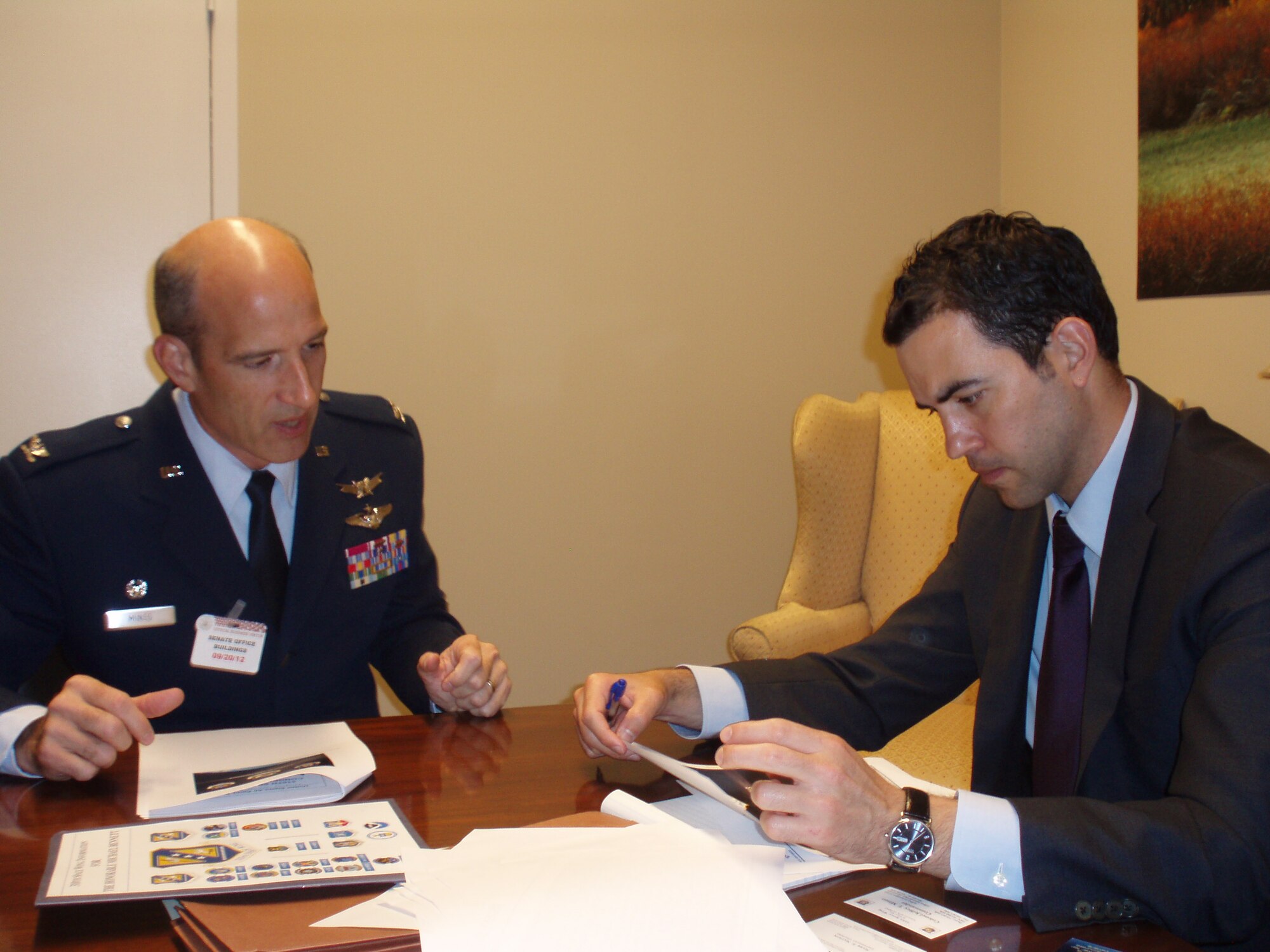 Col. Jeffrey Mineo, 310th Space Wing commander, talks to Jorge Rueda, a legislative aide to Sen. Michael Bennet of Colorado, about the wing's mission and contributions to national defense Sept. 20 in Washington, D.C. (U.S. Air Force photo/Lt. Col. Cindy East)