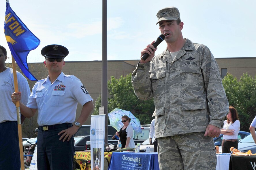 Air Force District of Washington Vice Commander Col. Michael E. Gantt welcomes runners and Combined Federal Campaign supporters during the AFDW CFC Kickoff Fun Run and Charity Fair, Sept. 26, on Joint Base Andrews, Md. Gantt thanked those who chose to be a part of the campaign and encouraged everyone to invite fellow Airmen and coworkers to give what they can in support of the charities involved. (U.S. Air Force photo by Senior Airman Steele C. G. Britton)