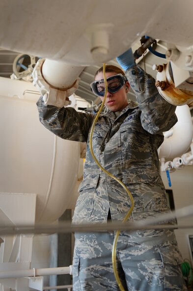 U.S. Air Force Senior Airman Megan O'Neil, 27th Special Operations Logistics Readiness Squadron fuels laboratory technician, gathers a fuel sample from a filter separator at Cannon Air Force Base, N.M., Sept. 4, 2012. Technicians in the fuels laboratory conducts hundreds of tests monthly to ensure quality fuel is used with Cannon's transient aircraft. (U.S. Air Force photo/Airman 1st Class Eboni Reece)